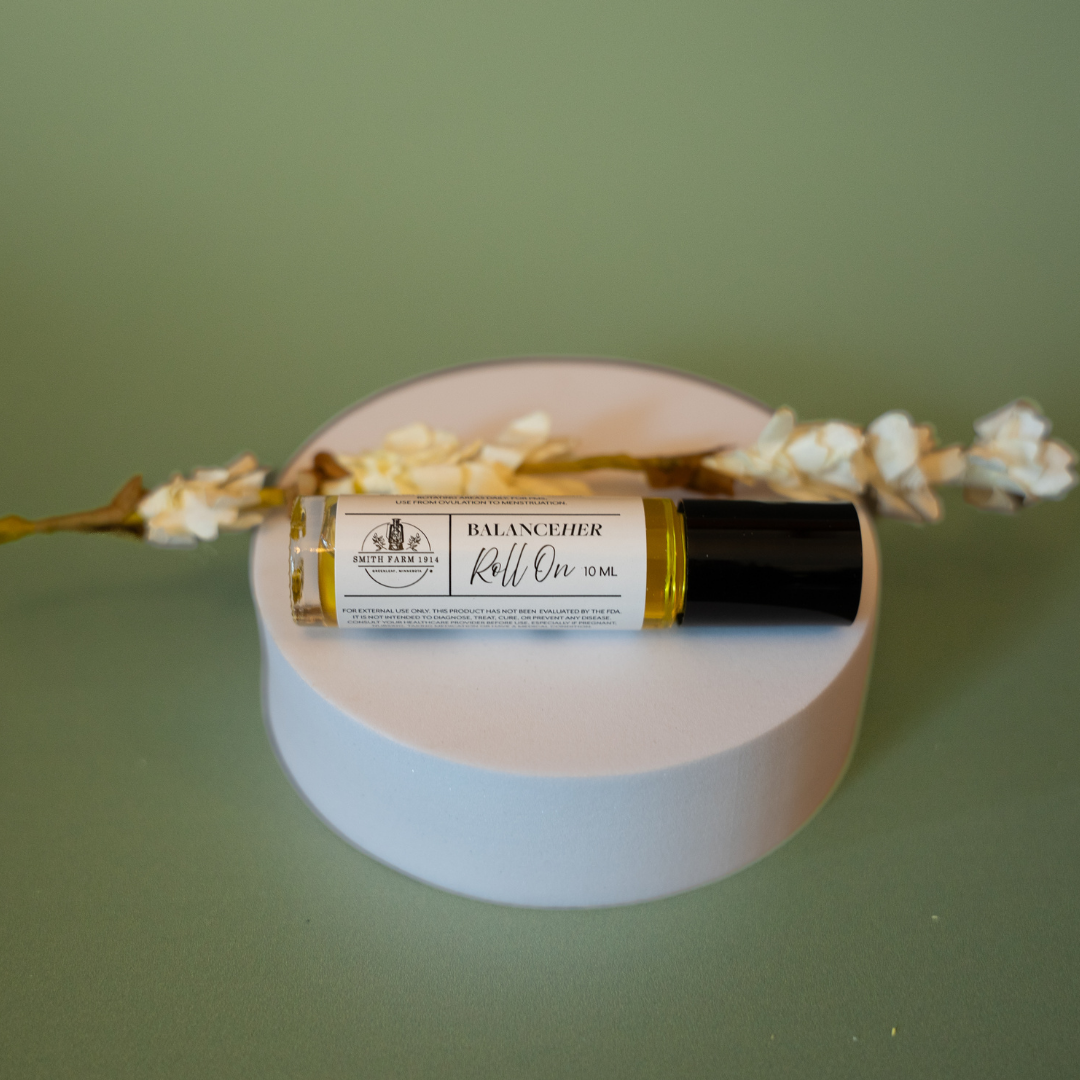 Roll-on bottle labeled 'Balance' on a round white platform with a green background