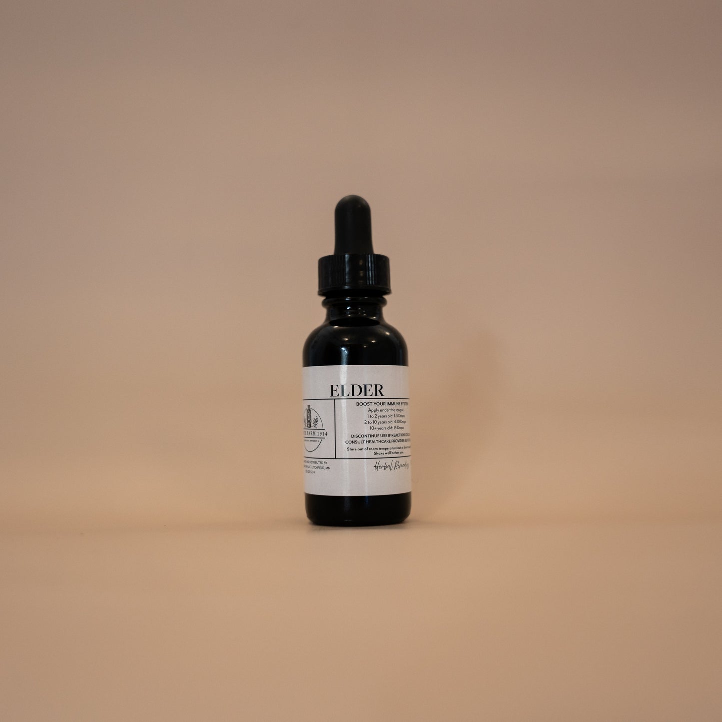 A bottle of Elder tincture with a dropper, set against a plain background.