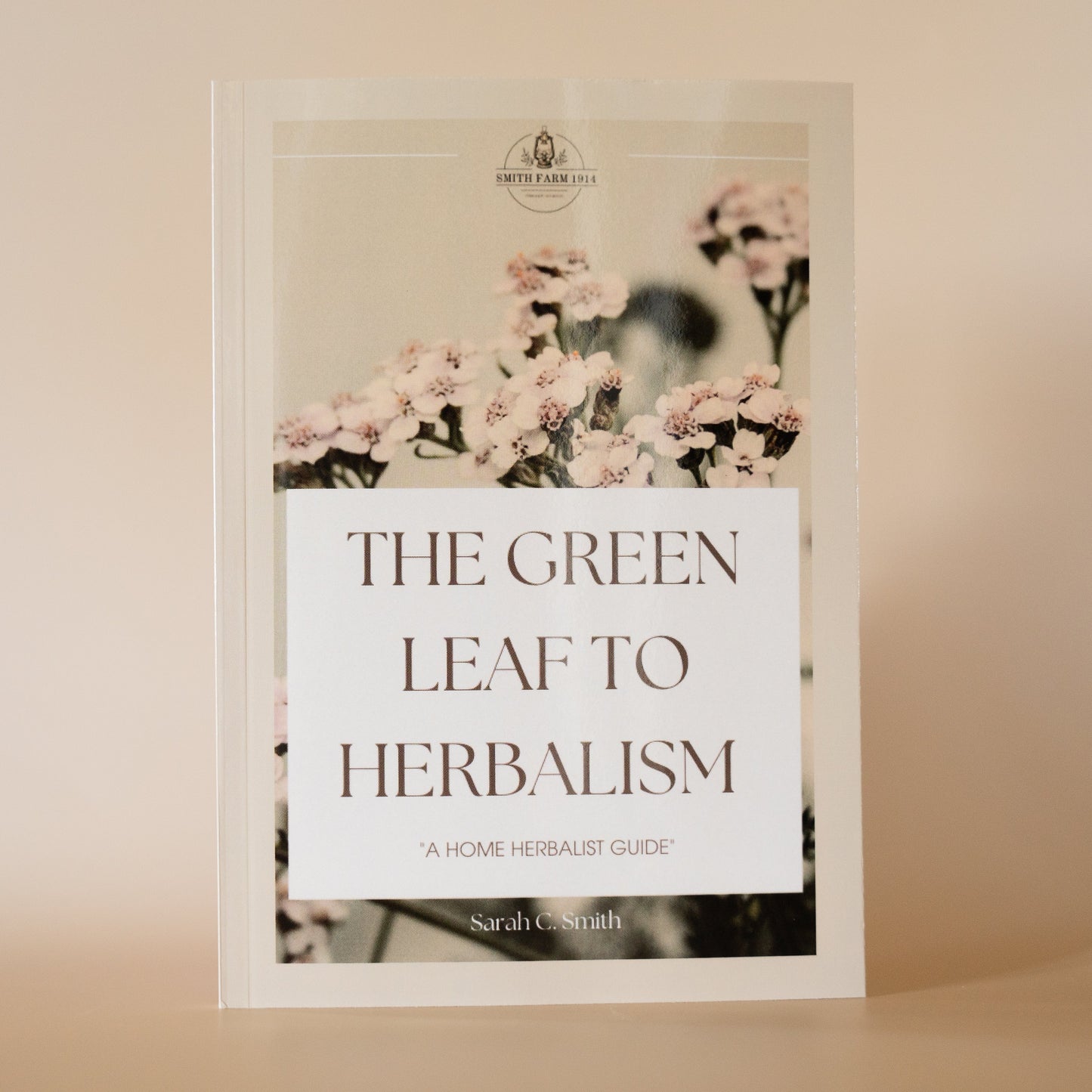 A book titled 'The Green Leaf to Herbalism' by Sarah Smith, featuring a floral design on the cover.