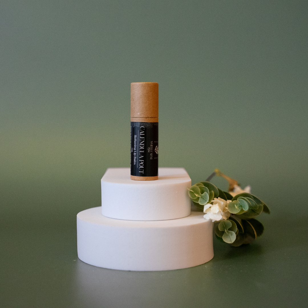 Skincare product with cork lid on a white stand against a green background