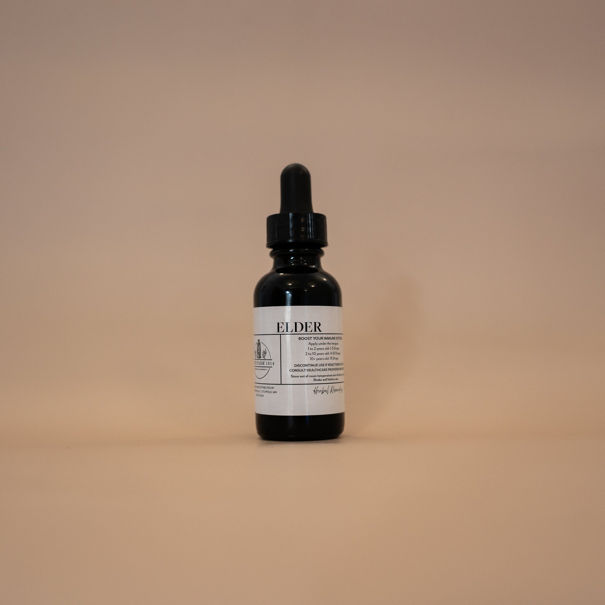 A bottle of Elder tincture with a dropper, set against a plain background.