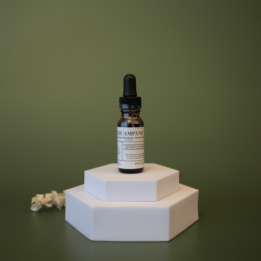 Bottle with dropper on a white hexagonal platform against a green background